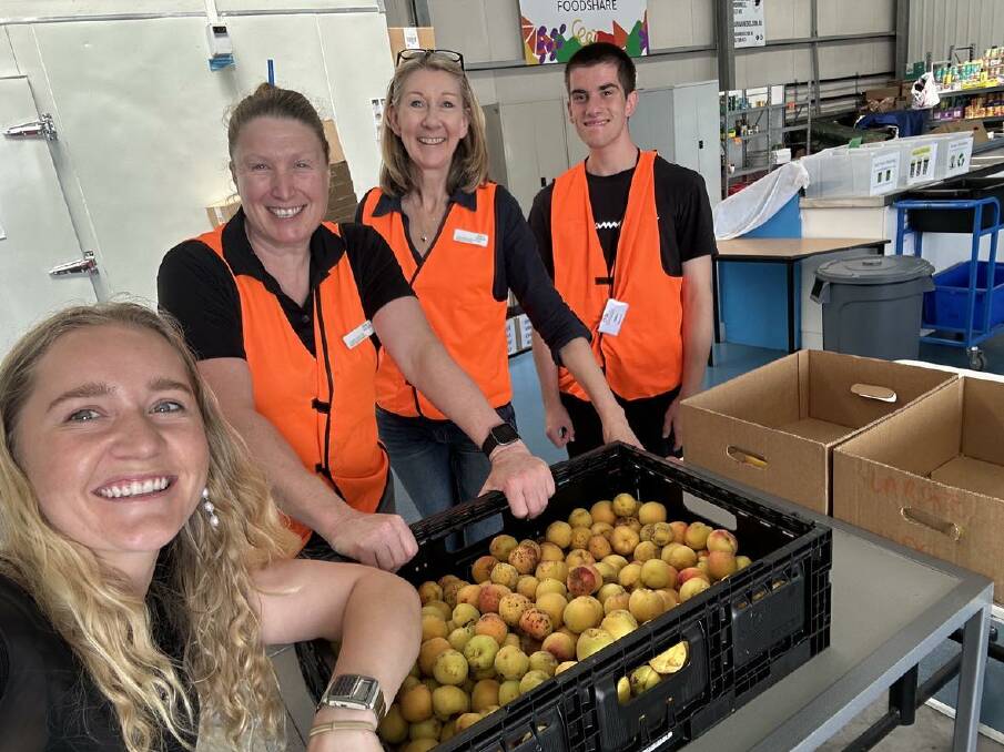 Fruit Rescue director Courtney Mathew (left) and Western District Food Share executive officer Amanda Hennessy with Food Share members. Picture supplied