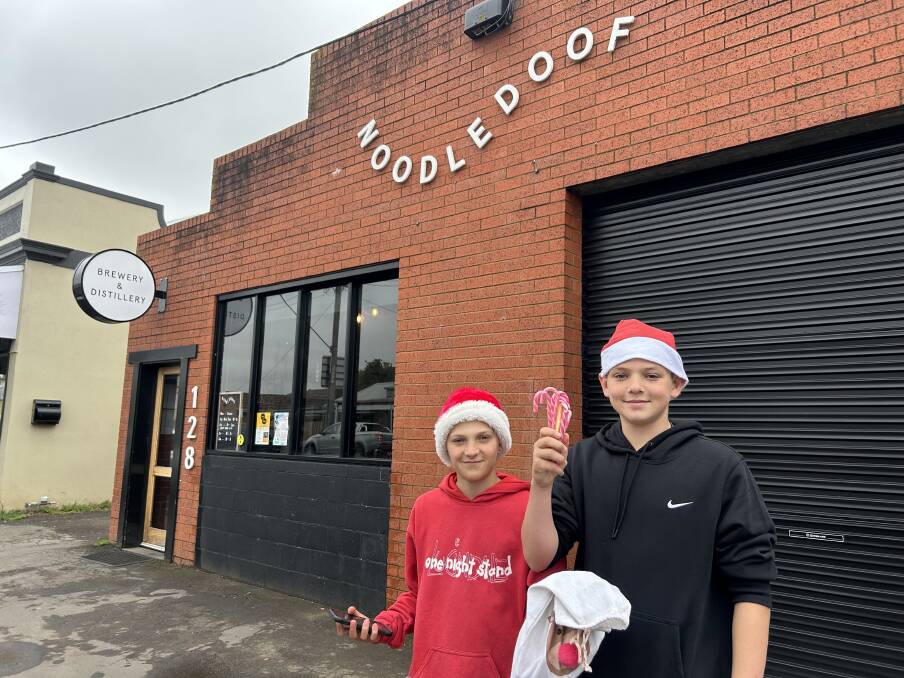 Felix Rudolph and his friend Ryan Wilkie, both 12, were seen handing out candy canes on Christmas Day during Noodledoof's first community breakfast. Picture by Jessica Howard
