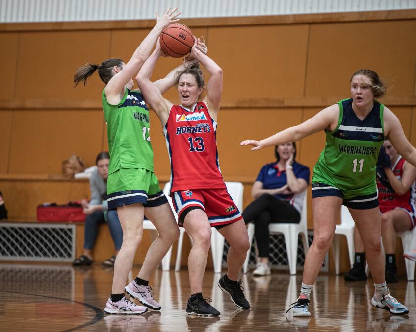 Warrnambool Mermaids' Jenny Henderson and Horsham Hornets' Emalie Iredell contest the ball on Saturday night. Picture by Sean McKenna