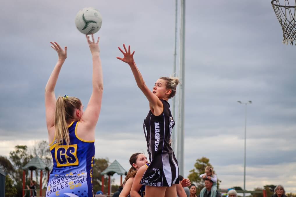 North Warrnambool Eagles' Chelsea Quinn aims for the goal ring as Camperdown's Lily Eldridge defends. Picture by Justine McCullagh-Beasy 