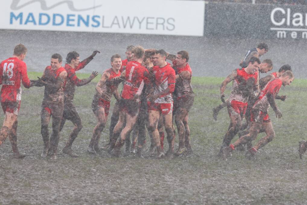 South Warrnambool players celebrate a goal as rain pours on Saturday. Picture by Eddie Guerrero 