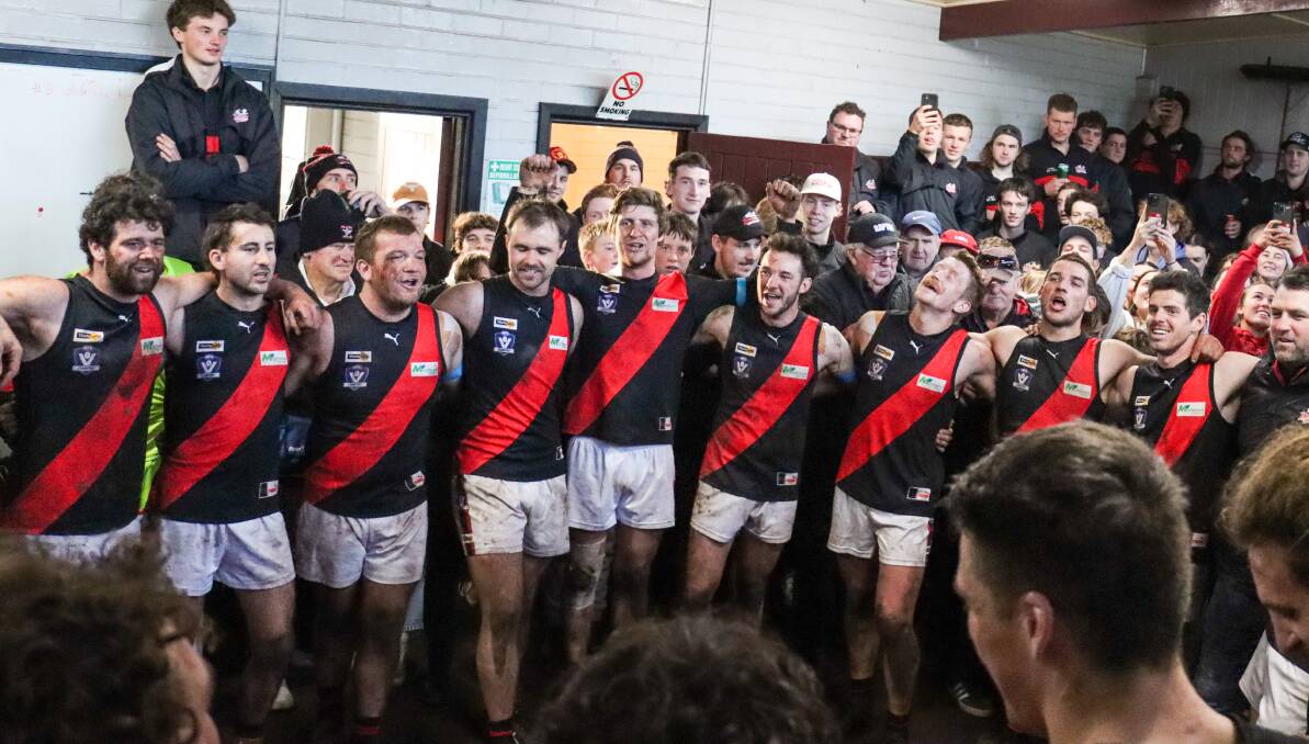 Cobden players belt out the Bombers' song in a jam-packed change rooms on Saturday. Pictures by Justine McCullagh-Beasy 