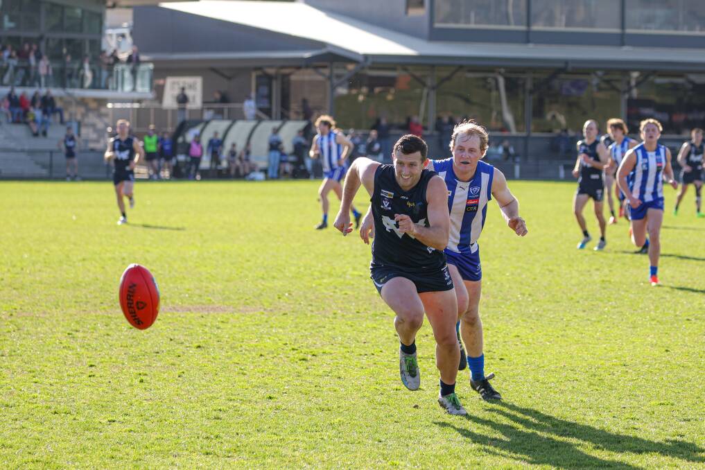 Warrnambool's Mitch Bidmade leads Hamilton Kangaroos Michael McMeel to the ball. Picture by Eddie Guerrero 
