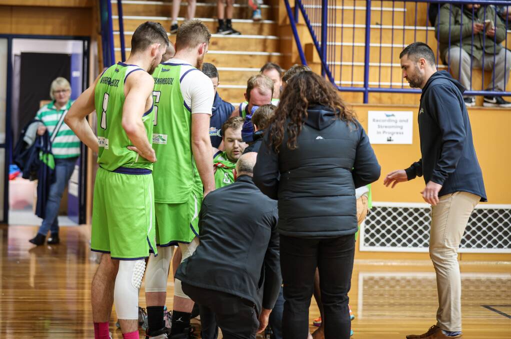 Liam Osborne is helped from the basketball court on Saturday night after injuring his knee. Picture by Sean McKenna 