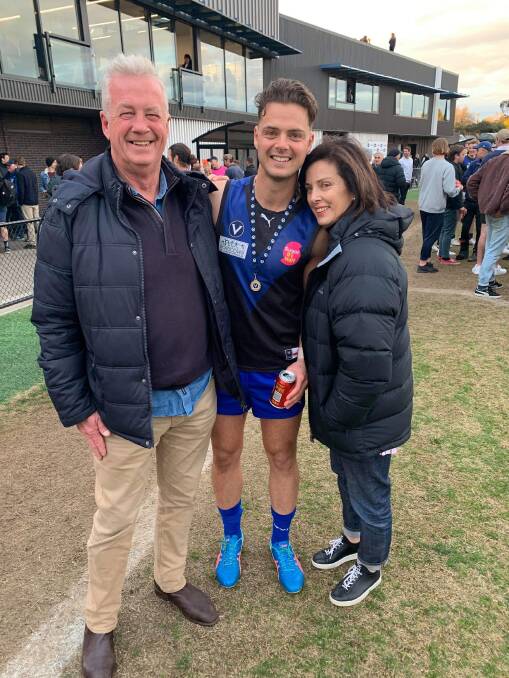 Jeremy Mugavin with his parents Noel and Leanne after University Blues won the 2019 VAFA premiership. Picture supplied 
