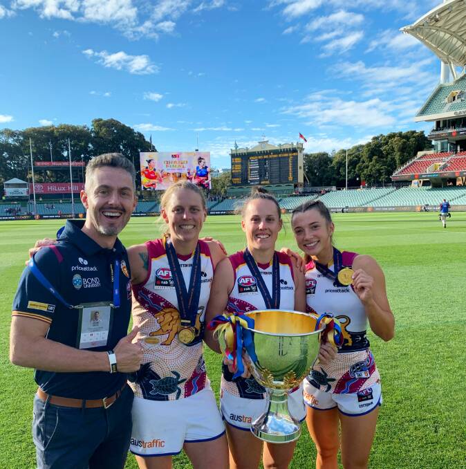 Jake Anson with 2021 Brisbane Lions AFLW premiership players. Kate Lutkins, Emma Zielke and Jade Ellenger. Picture supplied 