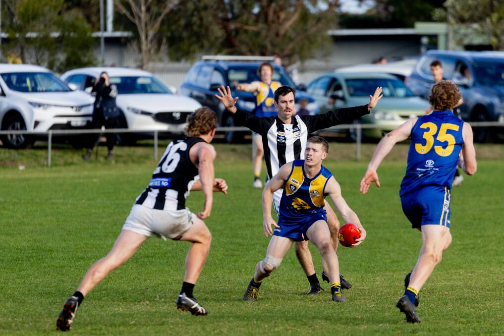 Tom Keast weaves his way through traffic for North Warrnambool Eagles. Picture by Anthony Brady 
