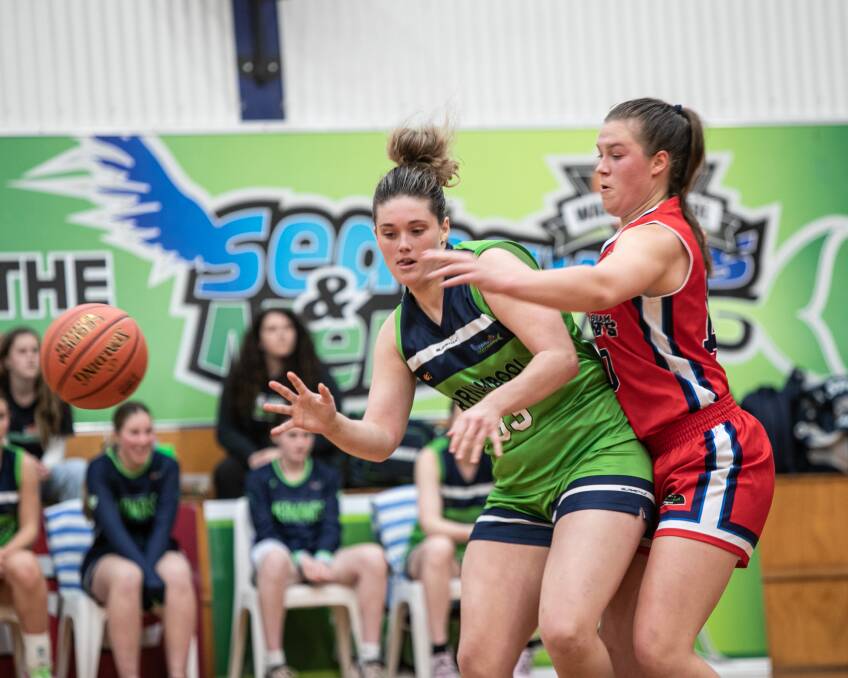 Warrnambool Mermaids' Molly McKinnon and Horsham Hornets' Jedah Huf battle for possession of the basketball. Picture by Sean McKenna 