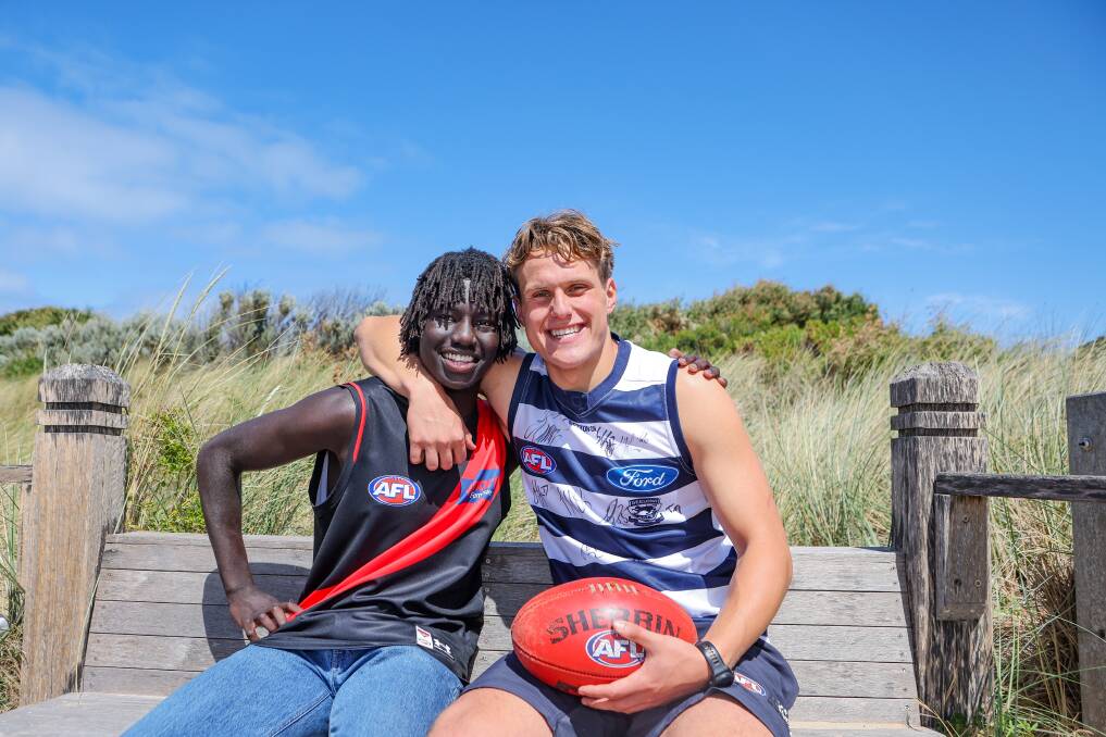 Essendon's Luamon Lual and Geelong's George Stevens celebrate making the AFL at Warrnambool beach the day after the draft. Picture by Anthony Brady 