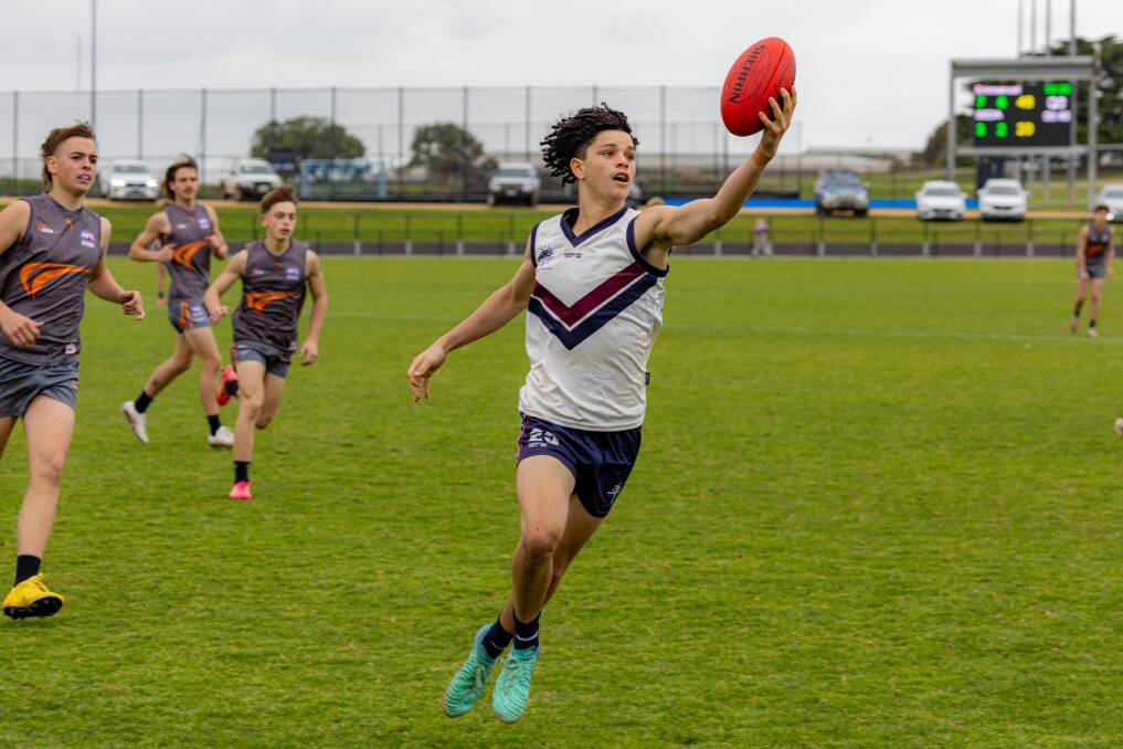 Des O'Keefe reels in the ball for Emmanuel College against SEDA at Reid Oval. Picture by Eddie Guerrero 