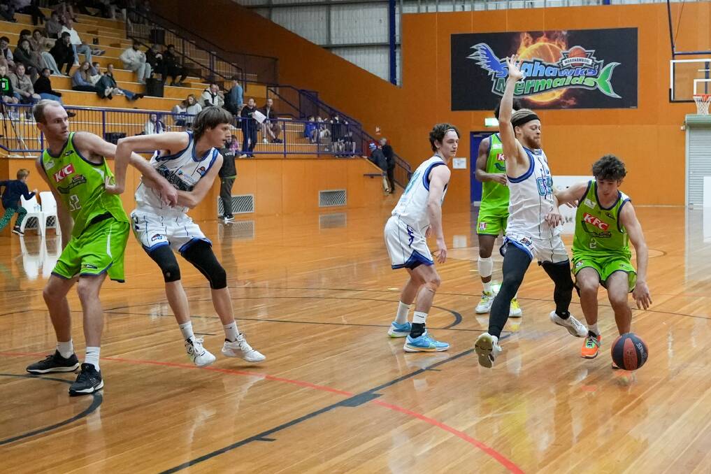 Teenager Josh Miller (far right) dribbles down the court for Warrnambool against Coburg. Picture by Larry Lawson 