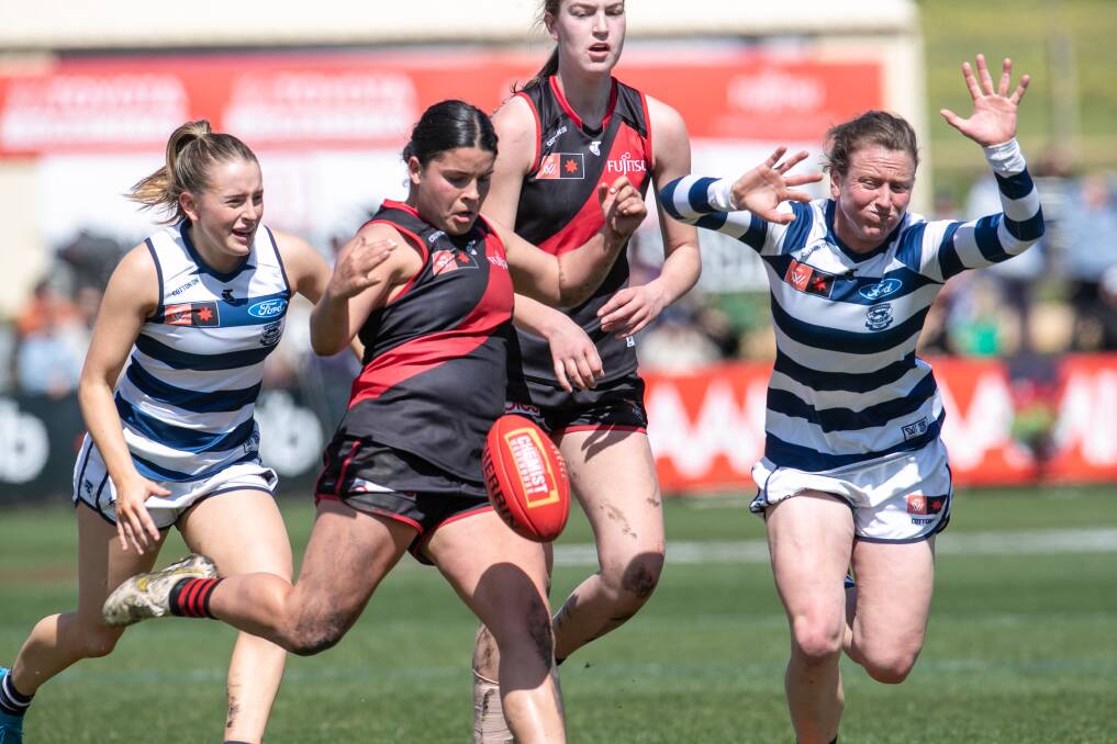 Essendon midfielder Maddy Prespakis boots the ball forward against Geelong during their match in Warrnambool in 2022. Picture by Sean McKenna 
