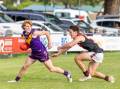 Port Fairy's Lucas King escapes the clutches of Cobden opponent Ben Berry at Gardens Oval. Picture by Eddie Guerrero 