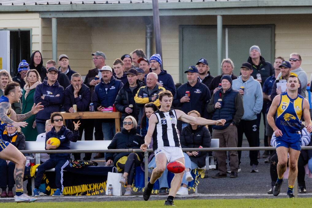 North Warrnambool Eagles crowd watches Camperdown's Harry Sumner kick the Magpies forward. Picture by Anthony Brady 