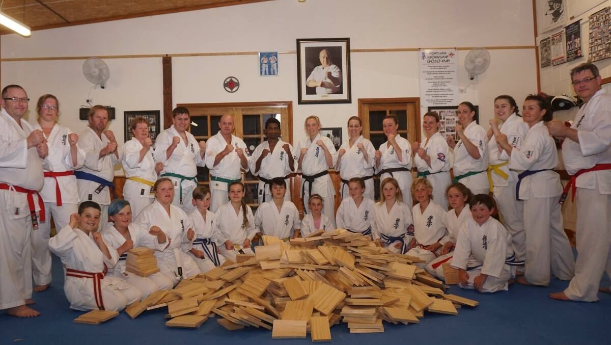 Warrnambool and Portland Kyokushin Karate students pose with the boards they broke for the Royal Children's Hospital Good Friday Appeal.