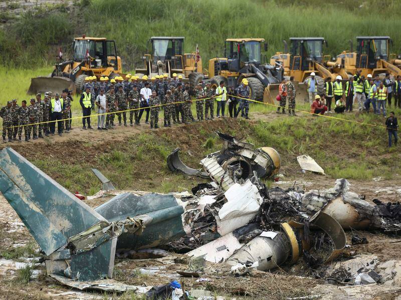 A 50-seater CRJ-200 aircraft crashed in a field beside a runway in Kathmandu, killing 18 people. Photo: AP PHOTO