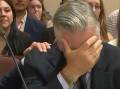 Actor Alec Baldwin weeps with relief after a judge threw out the manslaughter case against him. (AP PHOTO)