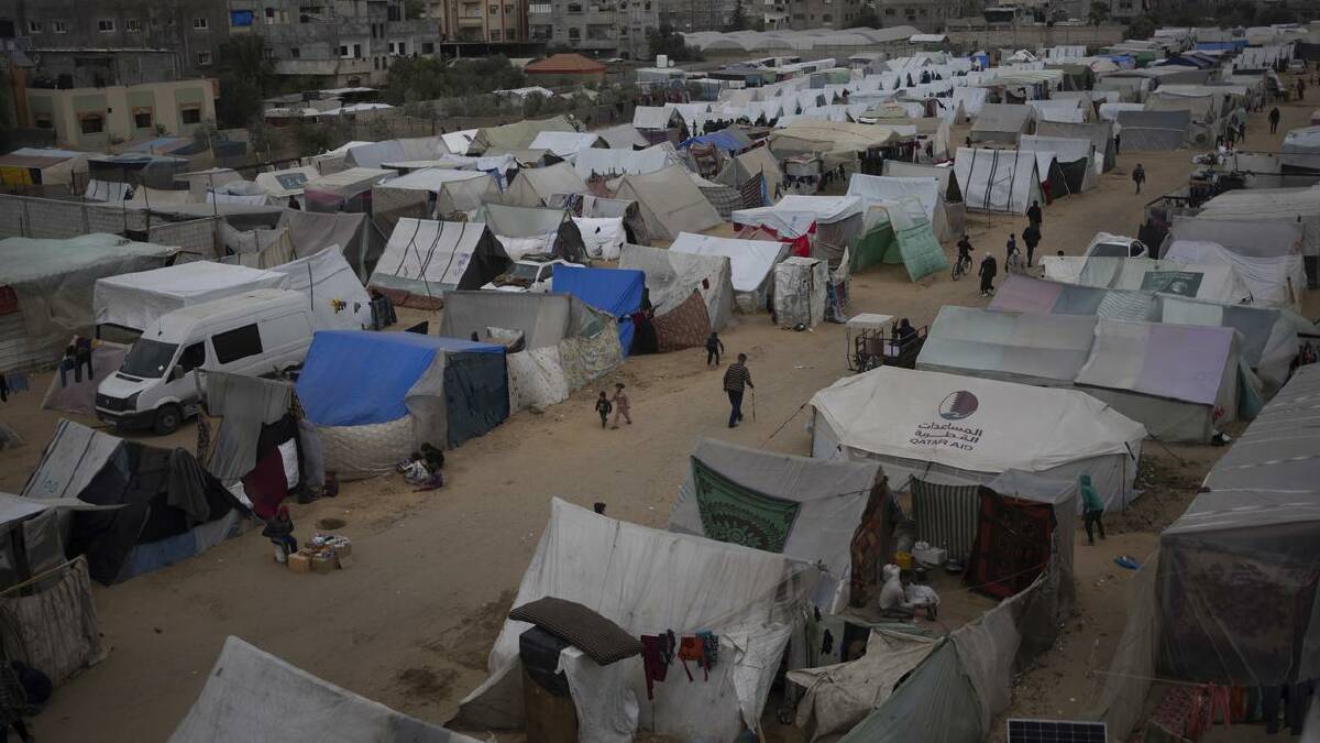 Palestinians displaced by the Israeli ground offensive at the makeshift tent camp in Rafah. (AP PHOTO)