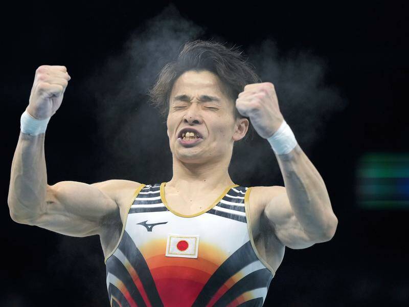 Takaaki Sugino celebrates after his pommel horse effort in Japan's team artistic gymnastics win. Photo: AP PHOTO