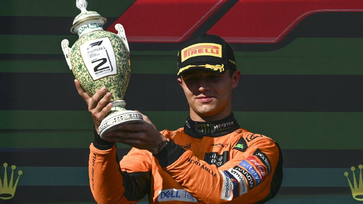 Oscar Piastri shows off  his trophy in Hungary but the victory was overshadowed by Lando Norris. (EPA PHOTO)