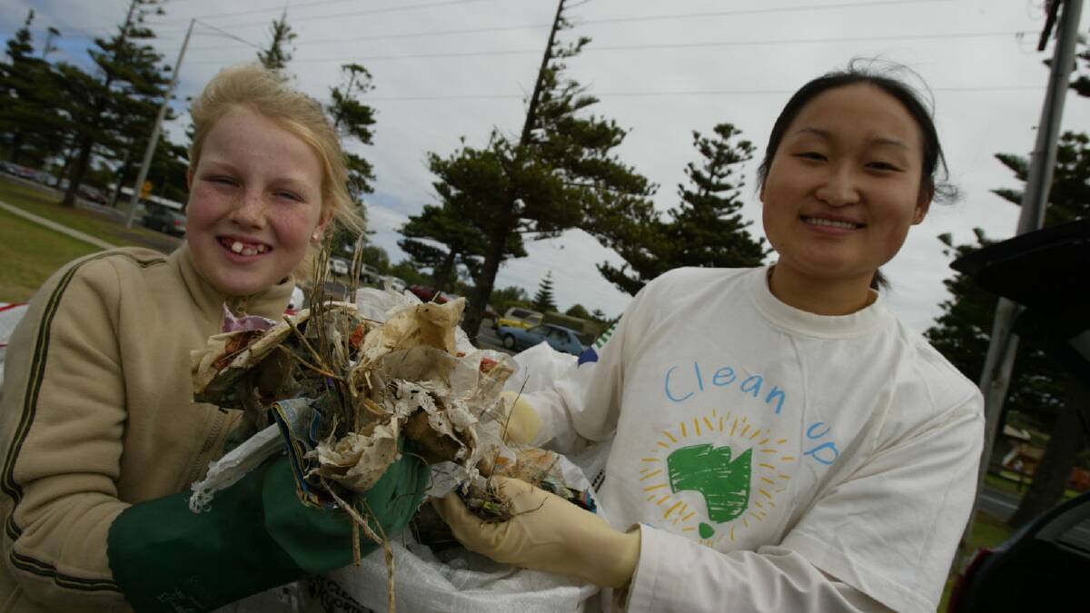 Isobel Elliott, 11, from Woodford and Laura Liu, 11, from Warrnambool clean up the foreshore area. 