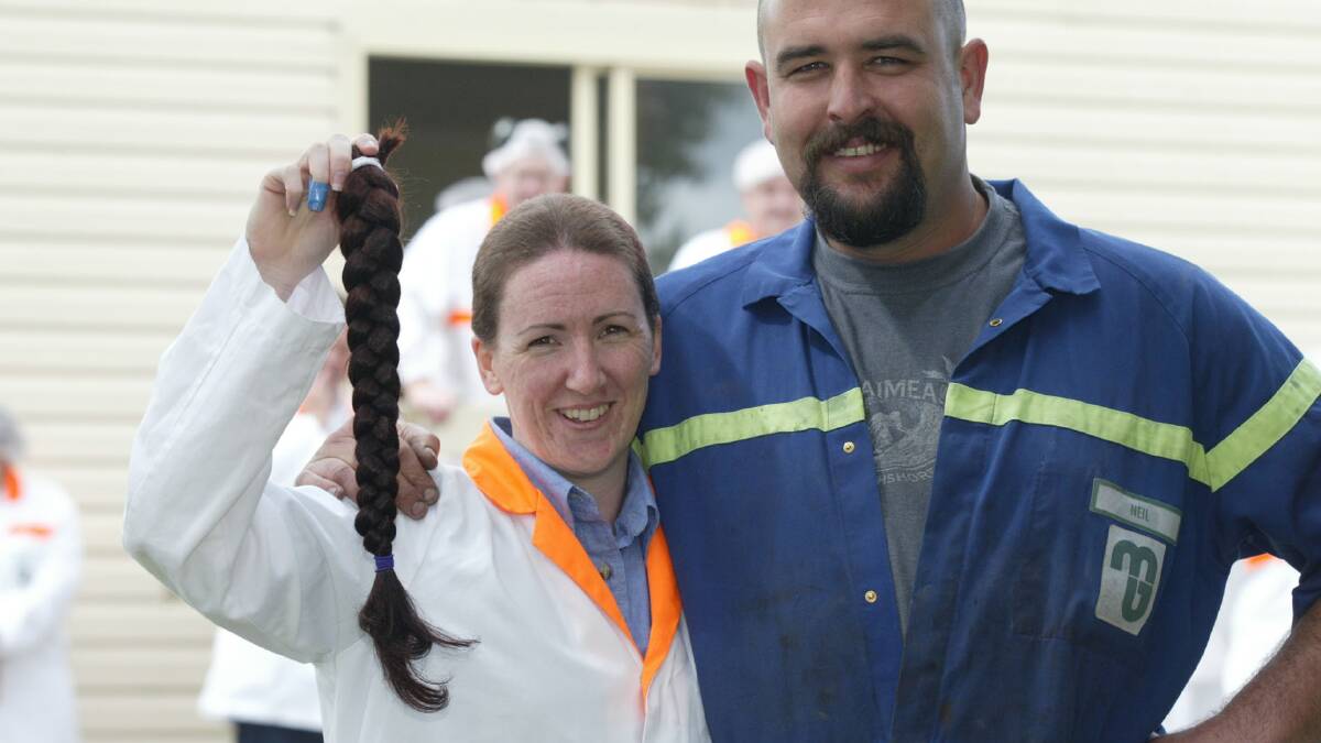 Murray Goulburn lab manager Jodie Falla and garage mechanic Neil Lowery after the  head shave.