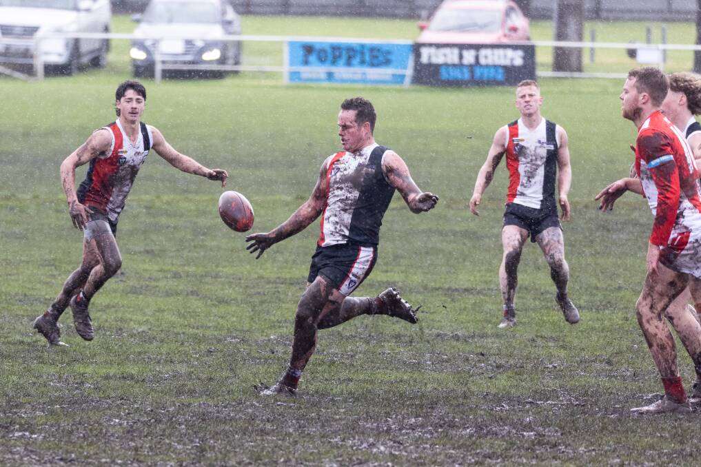 Koroit's Liam Hoy in action in the mud against South Warrnambool last Saturday. Picture Anthony Brady