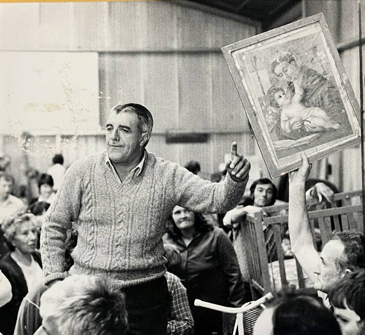 Auctioneer John Looney attempts to sell a holy picture during a St Pius X White Elephant Sale in the early 1980s. File Picture 
