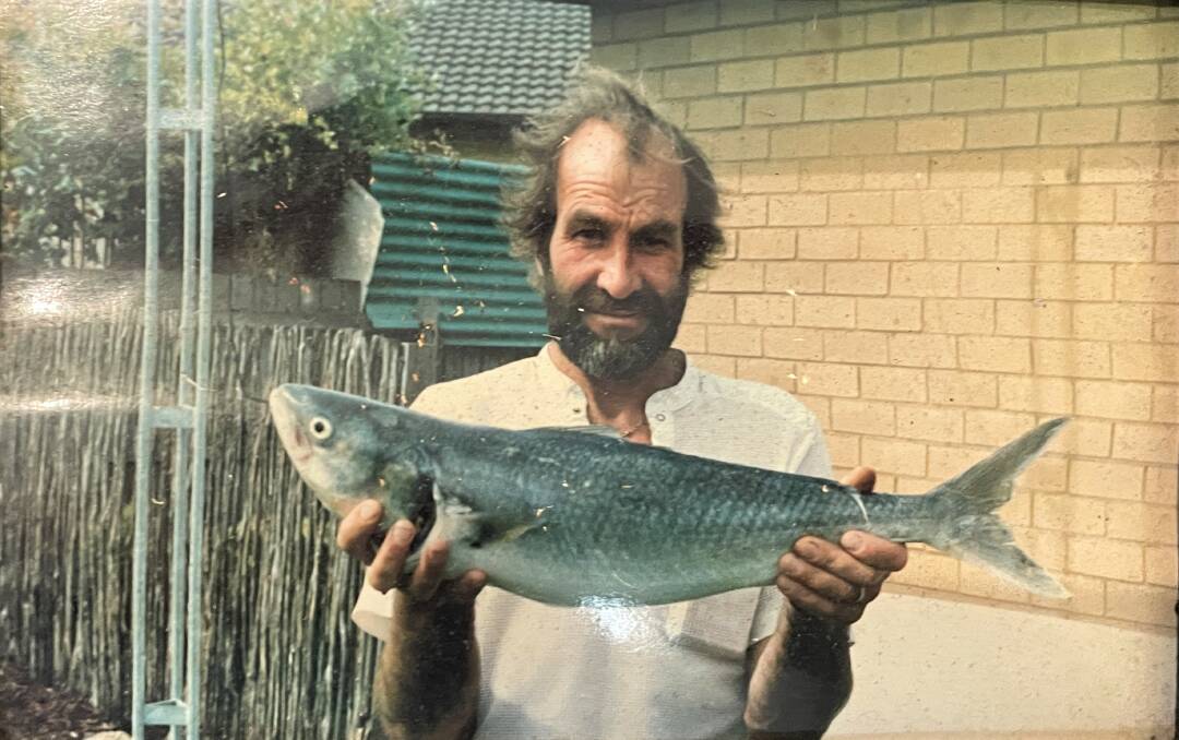 Alf Fish with one of the many fish he caught while working as a fisherman. 