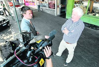 TV  reporter Rakhal Ebeli divines insights from Seanchai co-owner Roger Fitzgerald yesterday.