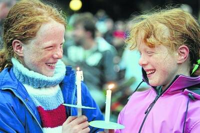 Twin sisters Katie and Abbie Hayward, 9, Warrnambool, light up their candles.  Picture:  ANGELA MILNE