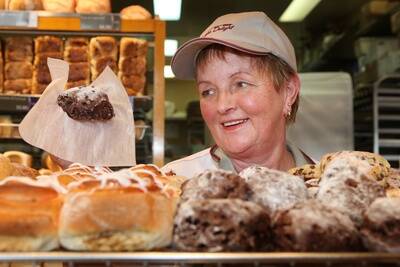 Warrnambool Chocolate Week.Pictured  Bakers Delight shop assistant Lois Morrow, holding a chocolate mud scone.        090930am13   PICTURE: ANGELA MILNE