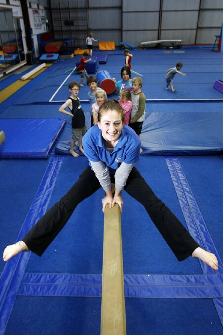 Warrnambool Springers gymnastics instructor Sian Ryan, 19, shows the next generation of young gymnasts a few moves on the balance beam. Sian has been participating in gymnastics for 15 years with the club, which is enjoying a surge in popularity.