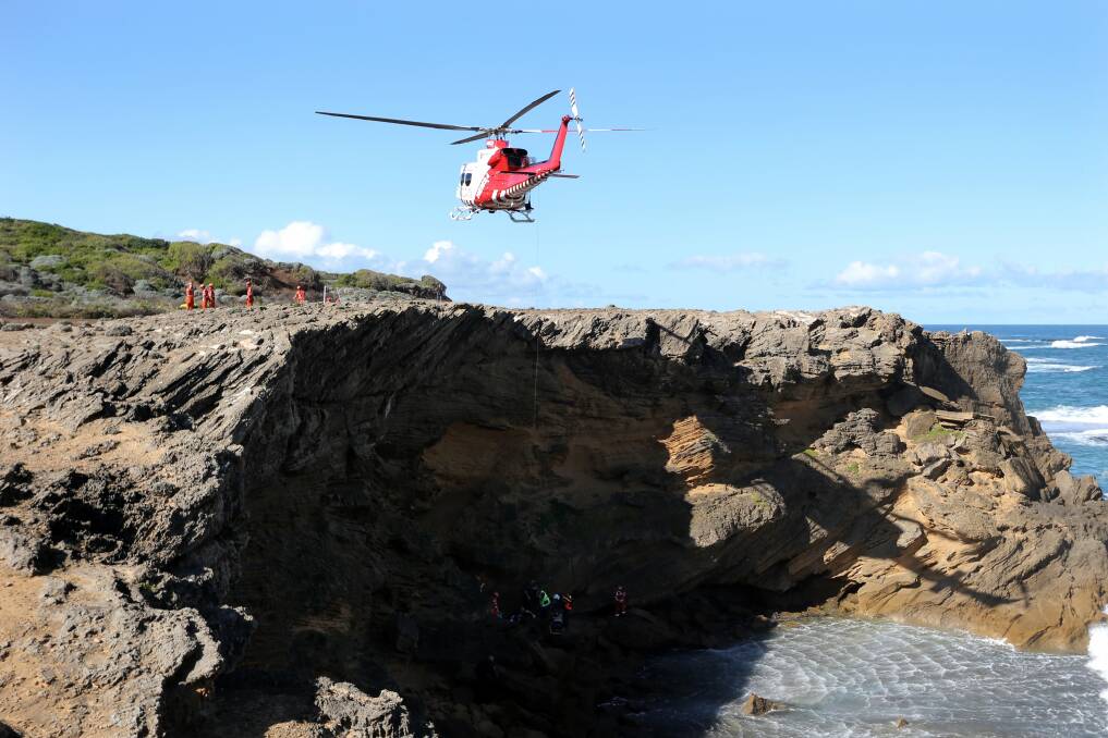 The rescue helicopter was used to retrieve a woman from the rocks after she fell over the cliff at Thunder Point in Warrnambool yesterday.