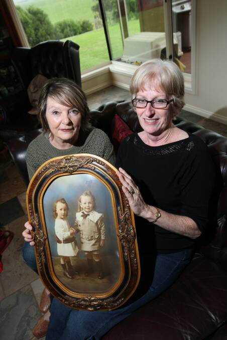 Maria Staaks (left) and Clare Dubay hold a photo of twins Maude Irene and Edward Francis Byron, aged about three, children of William Patrick Byron and Philomena (nee Carty). The family was farming at Nirranda at this time.