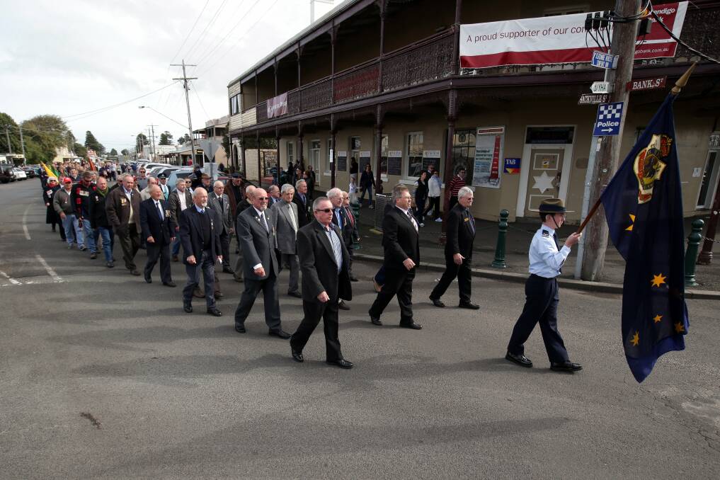 Ex-servicemen and other groups parade along Bank Street in Port Fairy. 