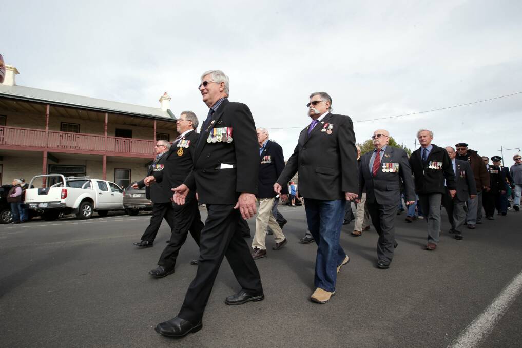Ex-servicemen and other groups parade along Bank Street in Port Fairy. 