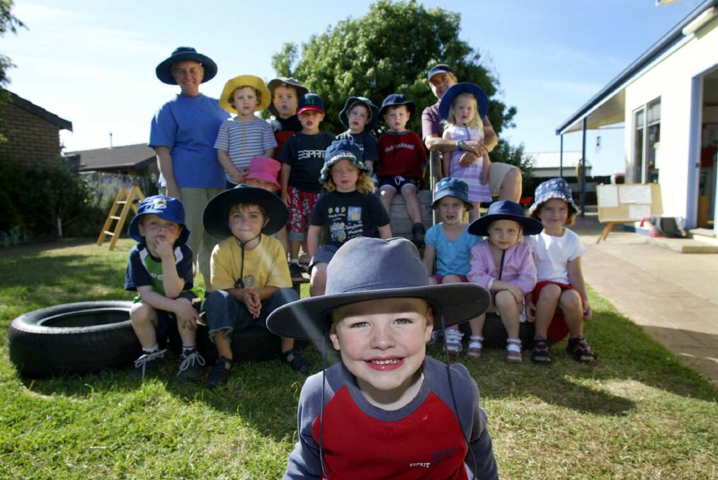 Panorama Avenue three-year-old kindergarten director Jane Brooker (left) and associate Pav Luke with some of the children on the playground (Harry Johns, 4, at front).