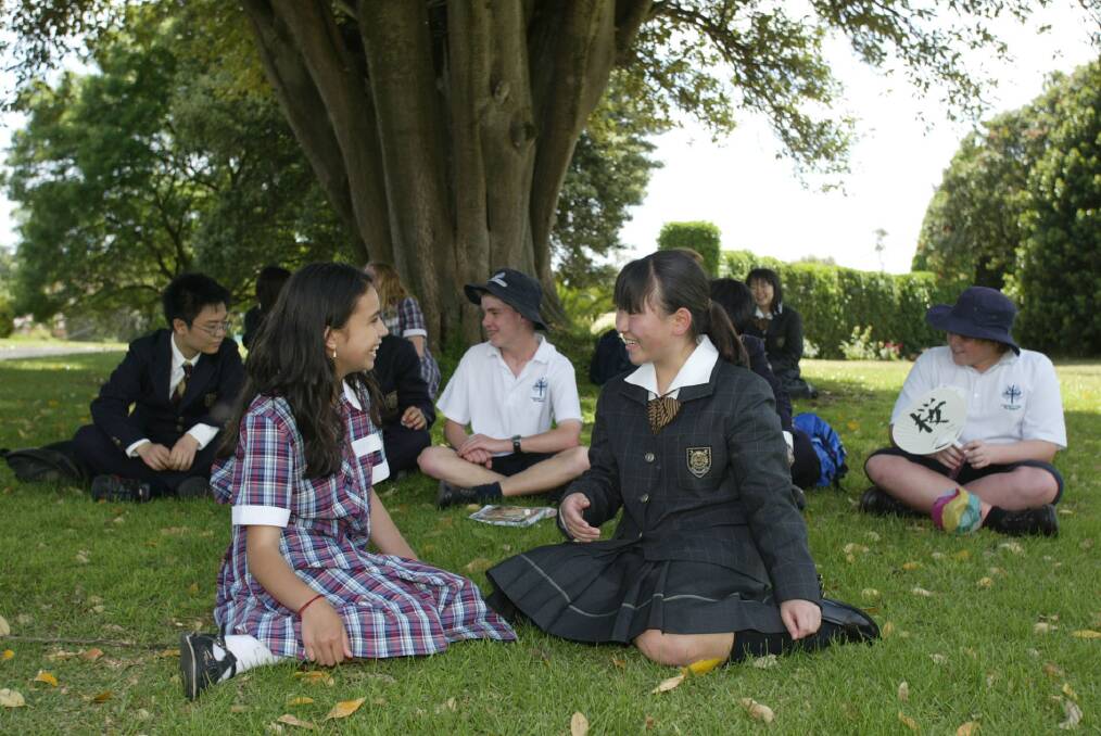Emmanuel college year seven student Lauren Pickett with her Japanese friend Tsuzumi Enomoto, 15, from Tokyo - who was part of a large group of Japanese students visiting the school for a day.