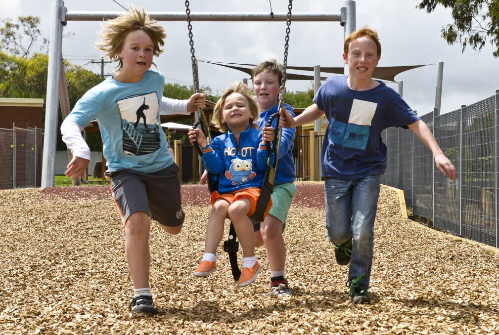 Five-year-old McLeod Duynhoven gets plenty of help on his flying fox ride from Darcy Duynhoven, 9, left, Eddie Mahony, 8, rear, and Will Mahony, 10, as the Bookaar youngsters try the Apex playground in Camperdown. Picture: STEVE HYNES