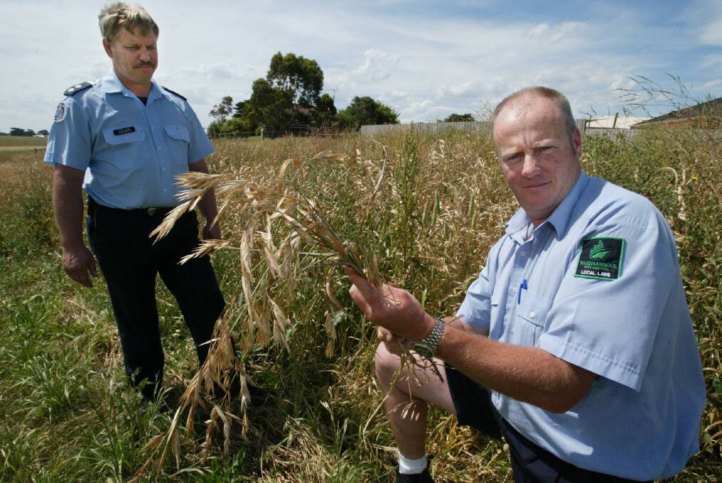 CFA fire officer Owen Maslen and fire prevention officer Peter McArdle warn people to cut down long grass in the Warrnambool area.