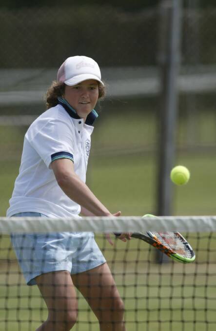 Tessa Barton, 15, hits a backhand at the net during the 18 girls doubles final. 